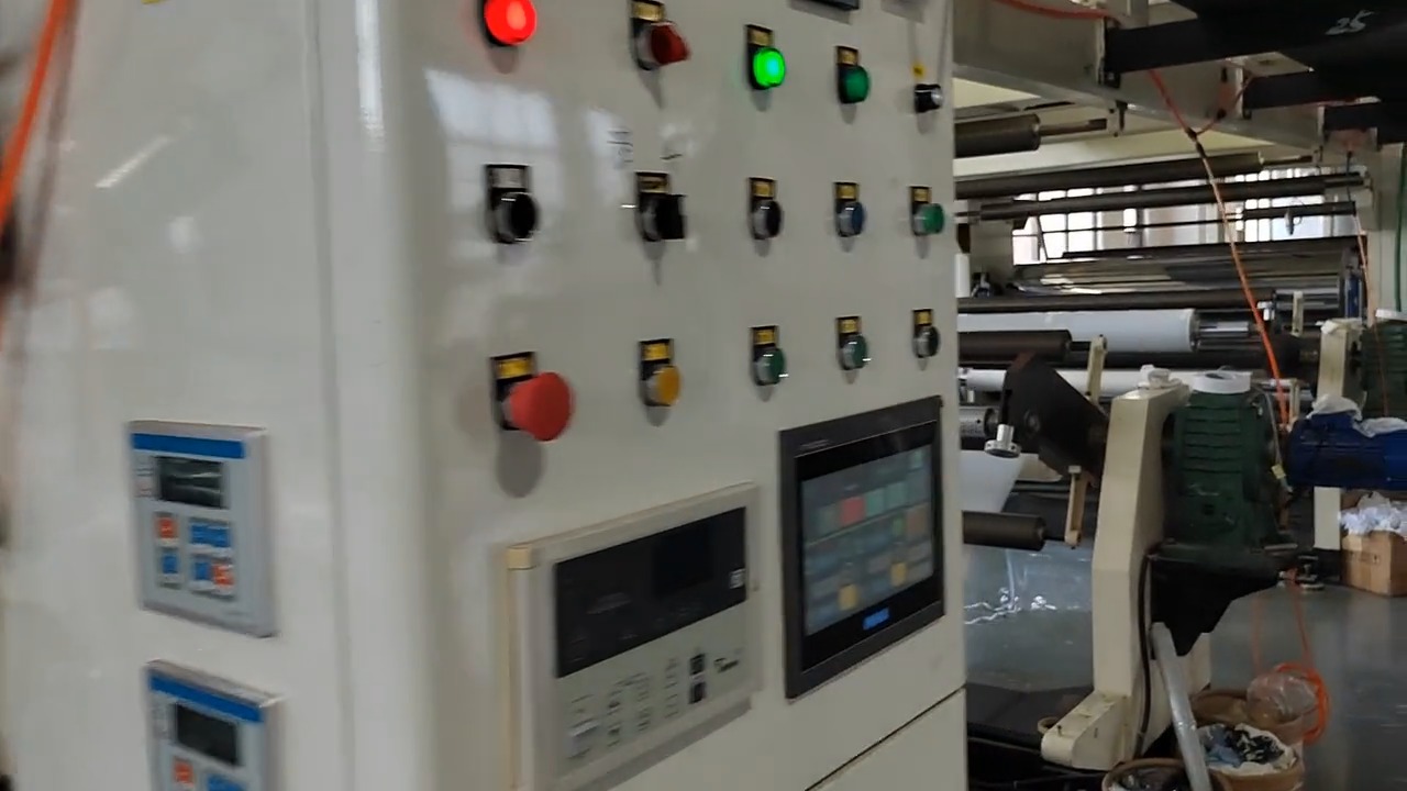 Coating-line control panel — emergency stop, indicator buttons and dual HMI touchscreens